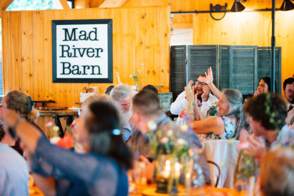 People laughing and celebrating at their tables in the events pavilion.