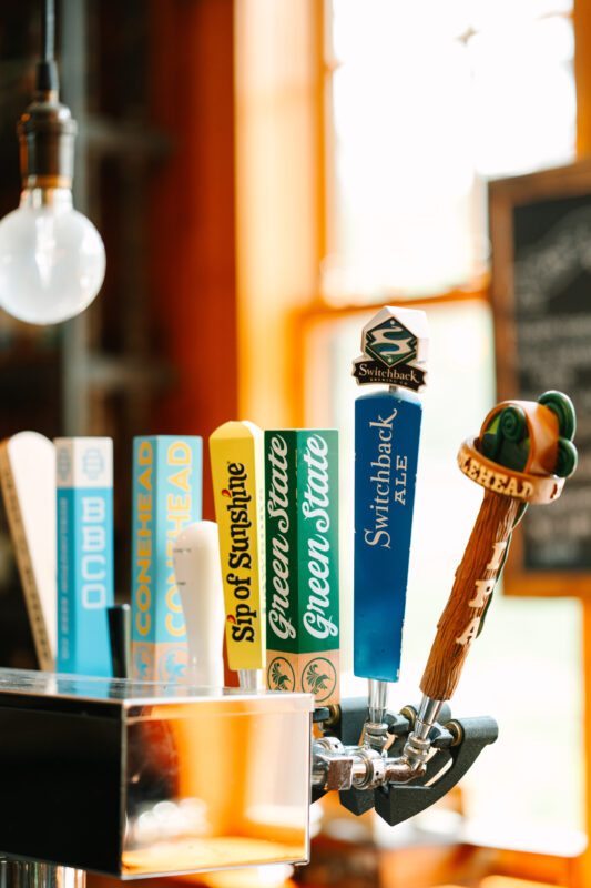 An image of the local draft beer taps behind the bar at the Mad River Barn