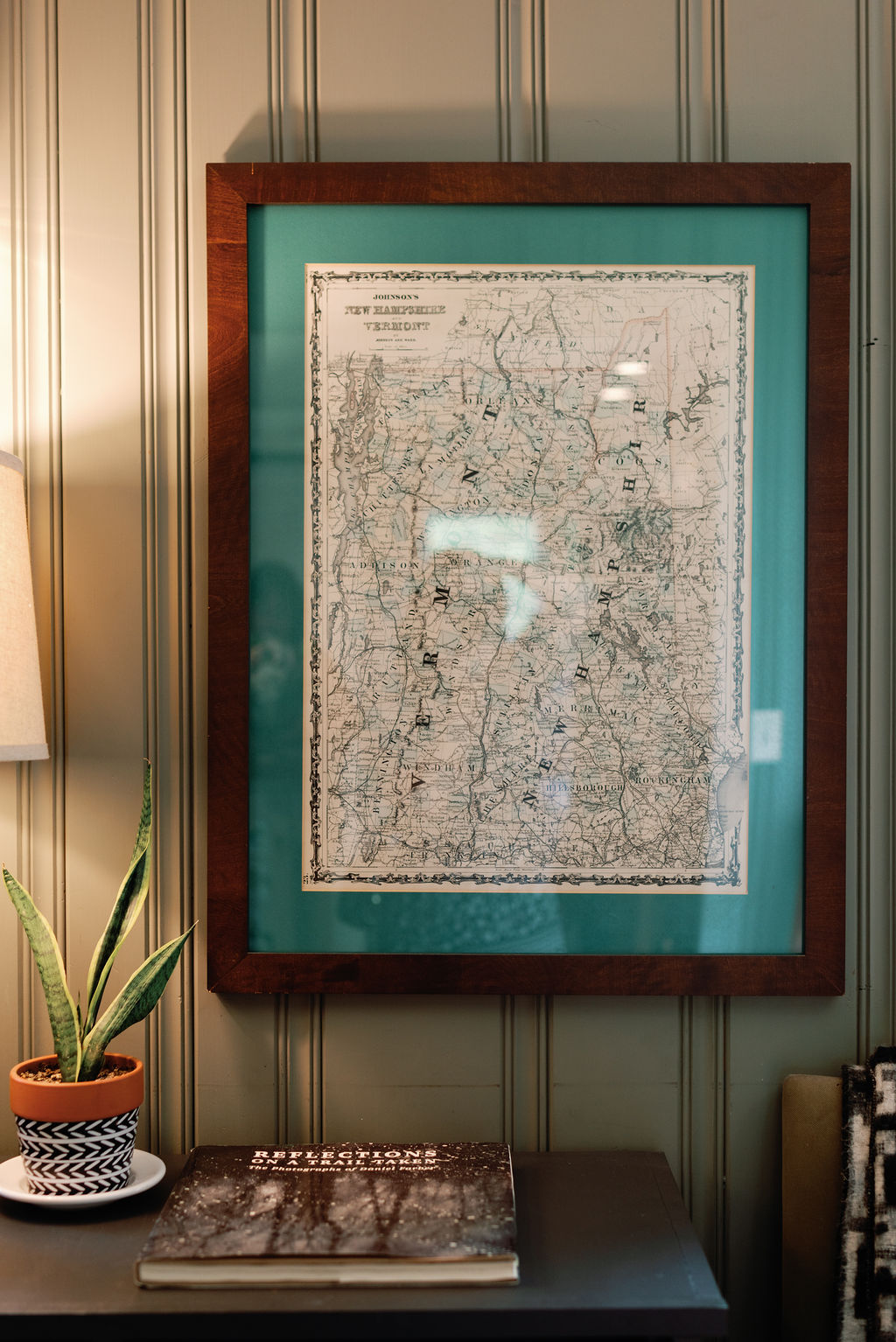 A framed map of the New Hampshire/Vermont state line that is located in the lobby of the Mad River Barn Inn