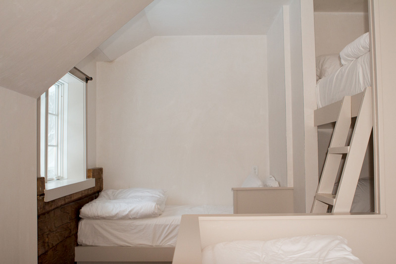 An Image of our Farmhouse Bunk Room "FH1" which is a private room with 6 twin beds and a private bathroom